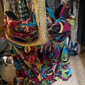 Multicolored tank top with gold lining and trim around the chest and neck.